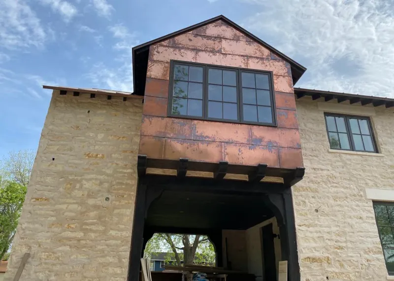 Copper metal panel facade on a stone building for Skylight Installation in Cedar Hill