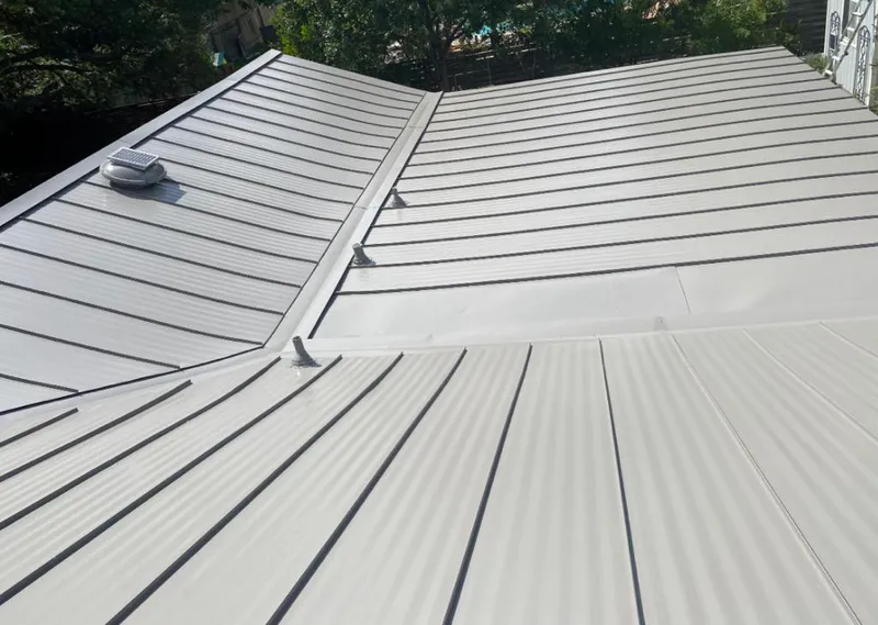 Solar attic fan installed on a metal roof for Roof Ventilation in Cedar Hill